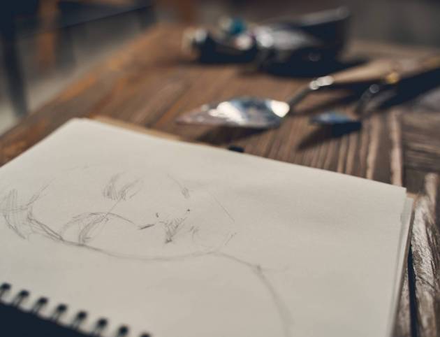 sketchbook-on-wooden-desk-with-art-supplies-2026-03-20-00-25-29-utc (1)